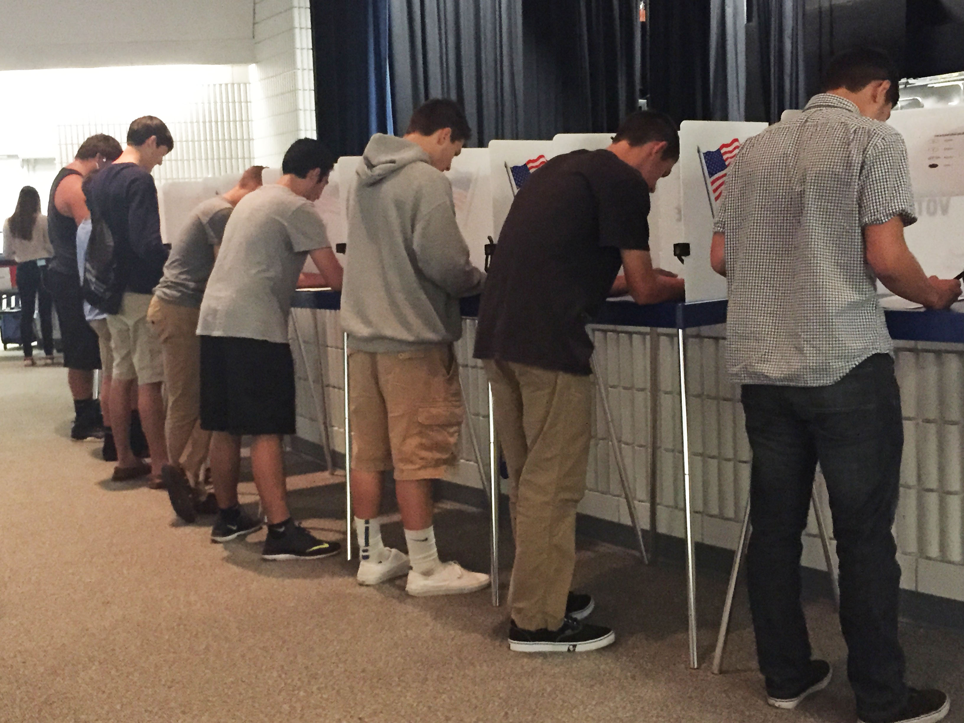 Photo pf students in voting booths filling out ballots for a school election